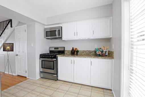 a kitchen with stainless steel appliances and white cabinets