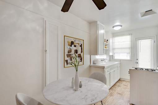 A white marble table with a vase on it in a kitchen.