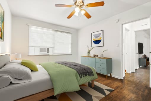 a bedroom with a bed and a ceiling fan