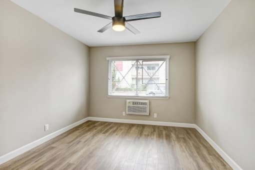 Bedroom With Ceiling Fan and Air Conditioning