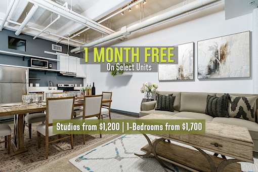 A room with a dining table and chairs is on sale with studios starting from $1,200 and 1-bedrooms from $1,700.