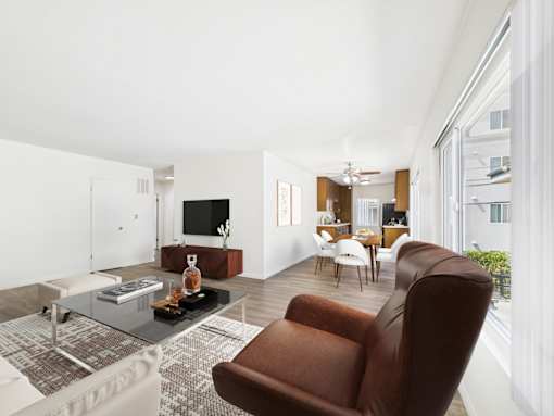 A modern living room with a brown leather chair and a glass coffee table.
