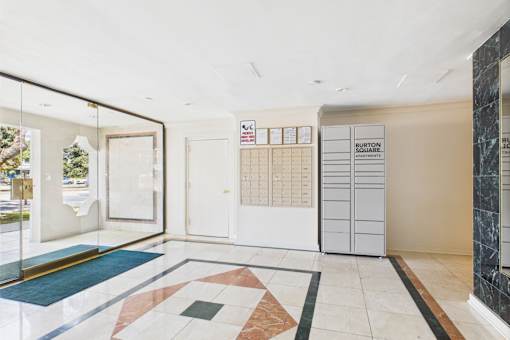 A Burton Boarding house lobby with a white door and a white wall.