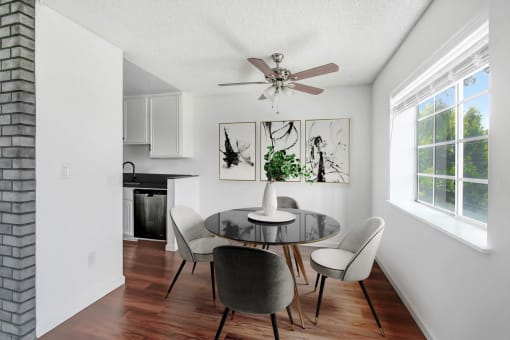 a dining room with a table and chairs and a ceiling fan