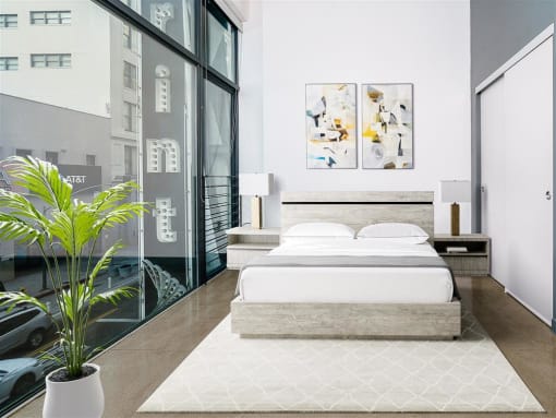 Studio Apartments In Downtown Los Angeles, CA - Broadway Lofts - High Ceiling Bedroom With Sliding Door Closet And Floor to Ceiling Large Windows