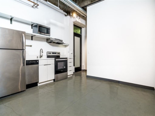 a kitchen with a refrigerator freezer and a stove top oven