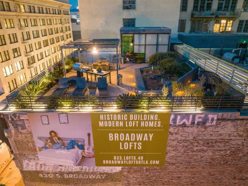 Downtown Los Angeles Apartments - Broadway Lofts - Rooftop Area With City Views, BBQ Area, Lounge Chairs, Gym, And Garden.