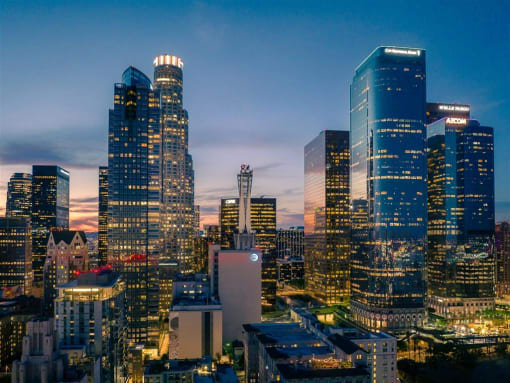 a view of the downtown los angeles skyline at dusk
