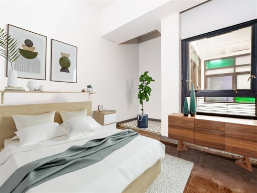 a bedroom with a large bed and a large window
