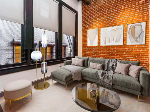 Apartments In Downtown Los Angeles, CA, for Rent - Broadway Lofts - Loft Style Living Room With High Ceilings, Exposed Brick Walls, Concrete Columns, And Floor-To-Ceilings Windows.