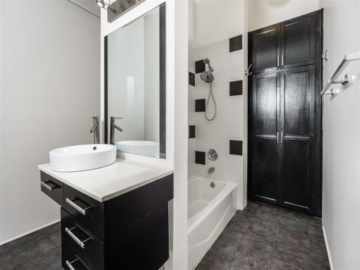 Lofts In Downtown Los Angeles, CA - Mercantile Lofts - Bathroom With Modern Features, Tiles, And Shower With Tub.