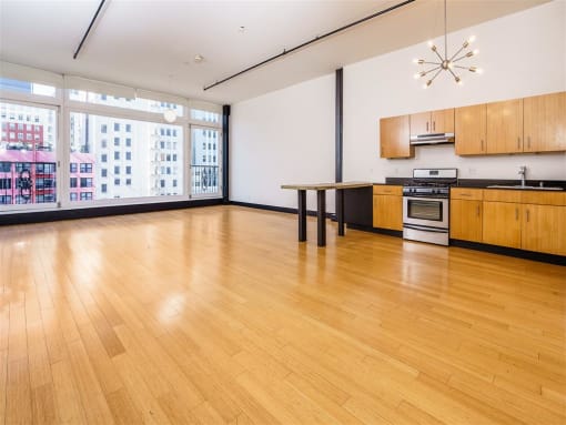 an empty room with a large window and a wooden floor