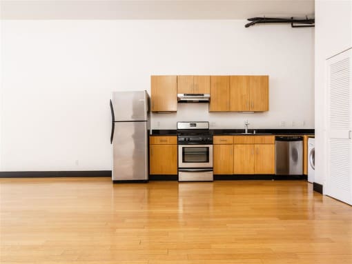 Downtown Los Angeles Apartments - Mercantile Lofts -Open Concept Kitchen With Bamboo Wood Flooring And Stainless Steel Kitchen Appliances