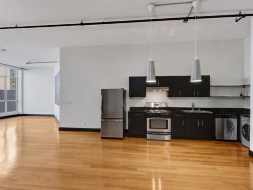 a kitchen with a stove top oven next to a refrigerator