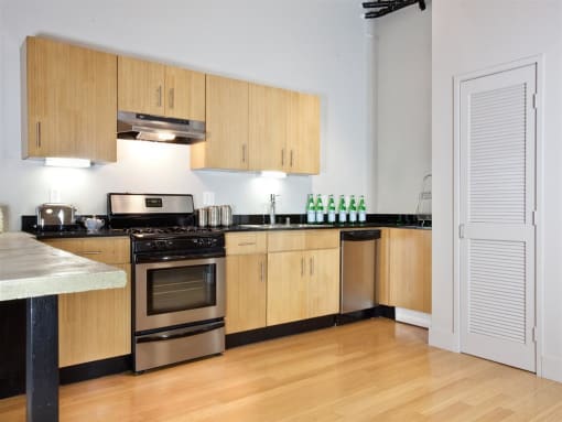 a kitchen with wooden cabinets and a stove top oven