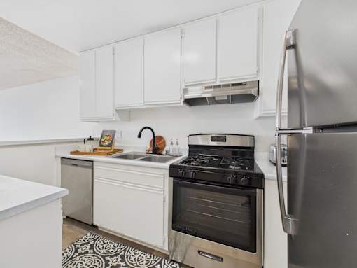 A kitchen with a stove, oven, and refrigerator.