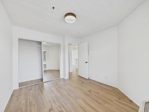 A room with white walls and wooden flooring.
