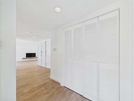 Closed white shutter doors in a room.