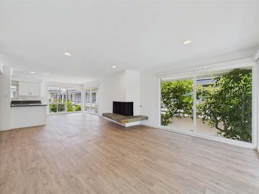 A spacious living room with a fireplace and sliding glass doors.