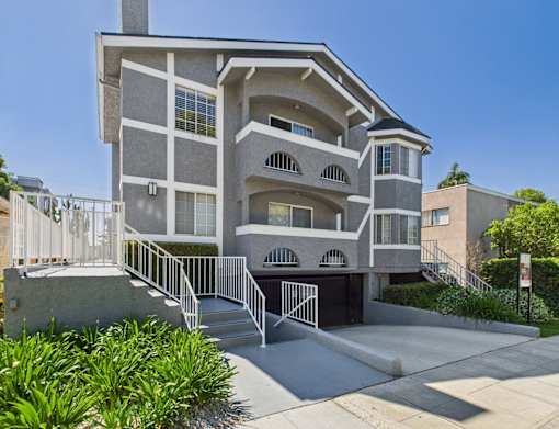A modern two-story house with a balcony and a garage.