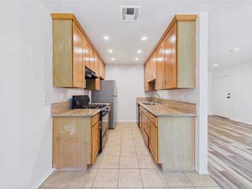 A kitchen with wooden cabinets and a countertop.