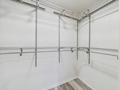 A white wall with a metal rack on it.