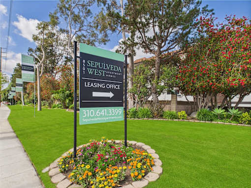 A sign for the leasing office of Sepulveda West apartments.