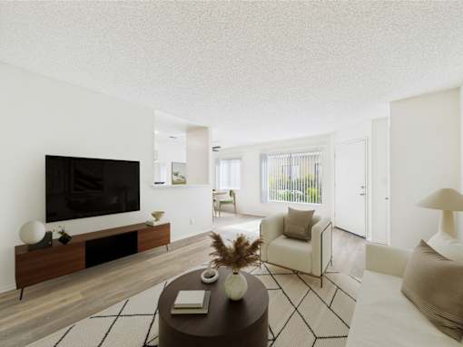 A modern living room with a flat screen TV and a coffee table.