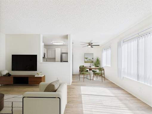 A living room with a television, a couch, a chair, and a dining table.