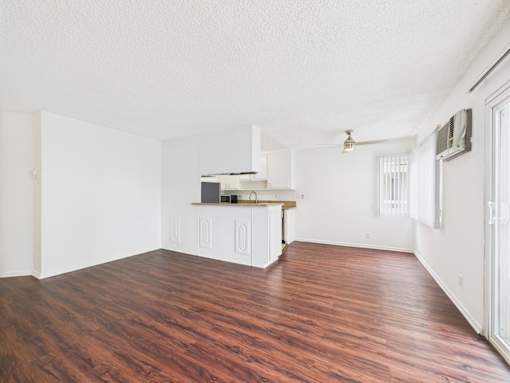 A kitchen area with a white cabinet and a countertop.
