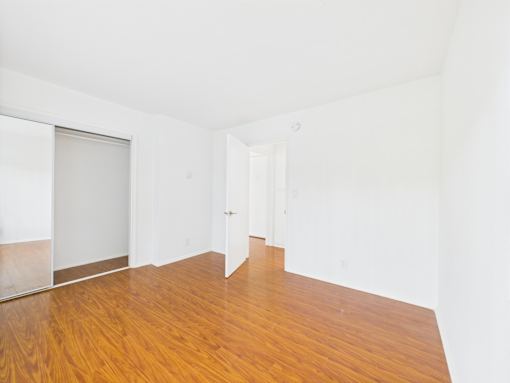 A room with a wooden floor and white walls.