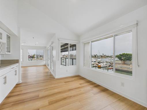 A long hallway with white walls and wood floors.