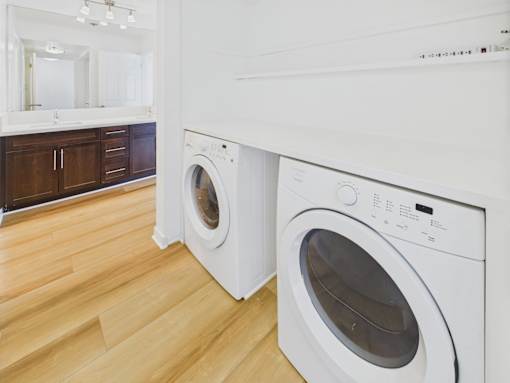 A white washing machine sits in a kitchen.