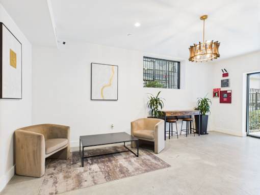 A living room with a couch, chair, and table.