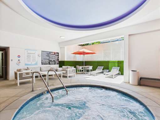 A round pool with a hot tub in the middle of it.
