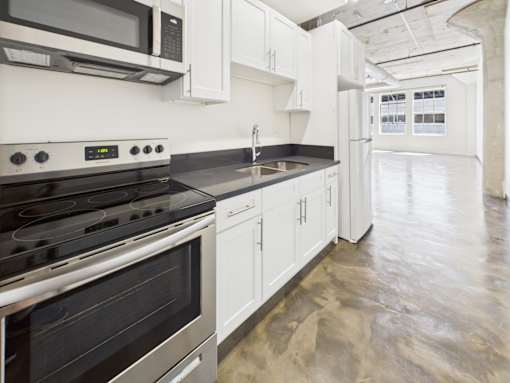 A kitchen with a stove top oven and microwave above it.