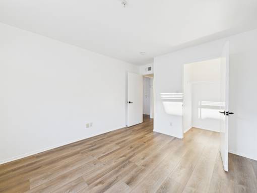 A room with a white door and a white sink.