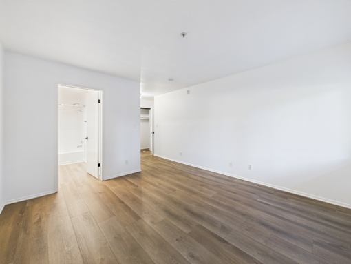 A room with wooden floors and white walls.