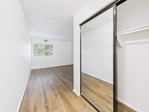 A room with a sliding door and wood flooring.