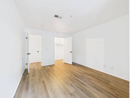 A room with wooden floors and white walls.