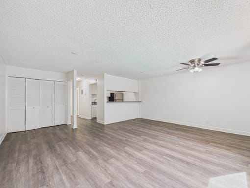 A room with a ceiling fan and light fixture.