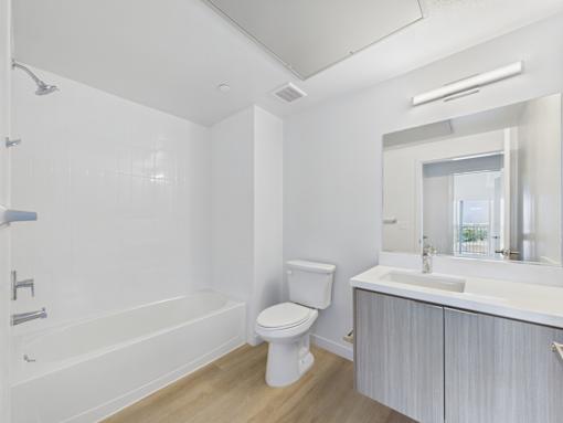 A white bathroom with a toilet, sink, and bathtub.