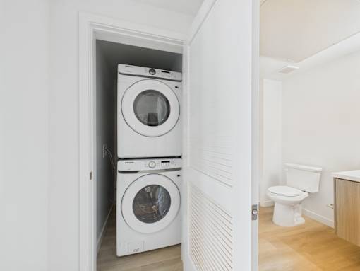 A white washing machine and dryer in a small laundry room.