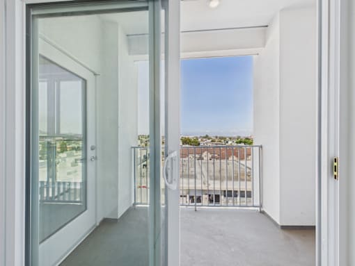 A view of a balcony through a glass door.