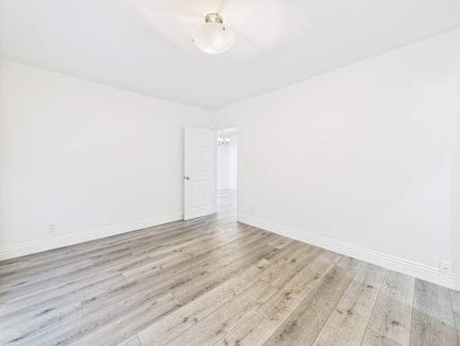 A room with a wooden floor and white walls.