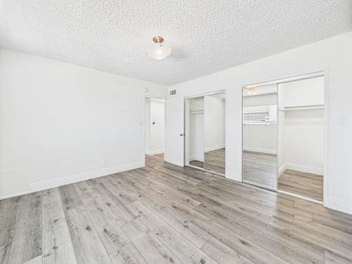 A room with a white ceiling and wooden flooring.