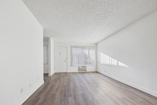 A room with wooden floors and white walls.