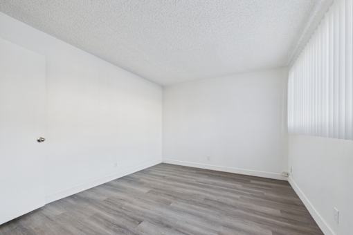 A room with a wooden floor and white walls.
