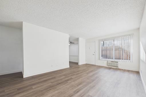 A room with wooden floors and white walls.