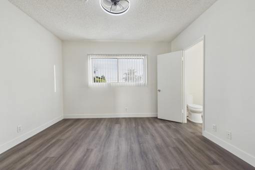 A room with a window and a toilet in it.